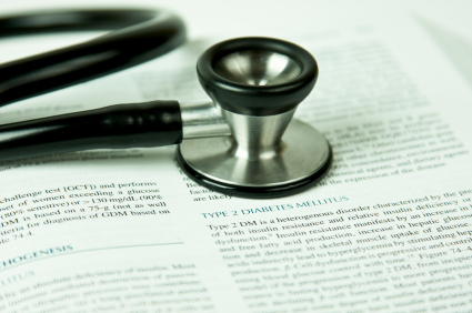Text book with stethescope on top.