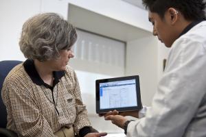 Woman and doctor looking at Ipad