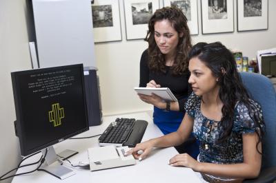 Women completing psychological test on a computer, administrator overlooking
